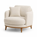 Fauteuil rond tissu bouclé crème avec coussin